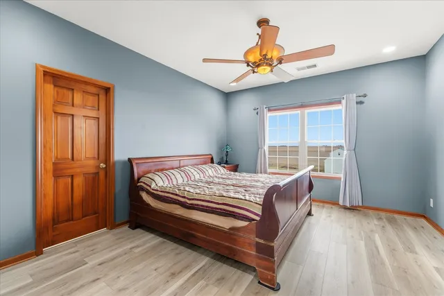 a bed sitting in a bedroom next to a window