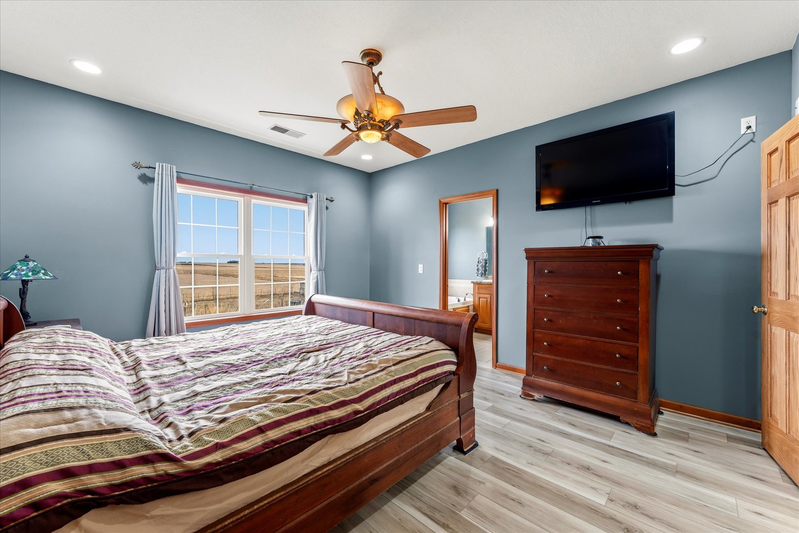 1376 East 2950 North Road Mansfield, IL 61854 - Photo 25 of 44 a bedroom with a bed and a flat screen tv