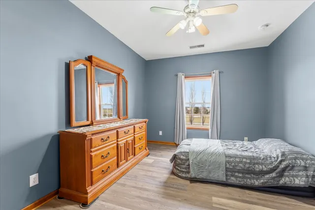 a living room with a bed next to a window