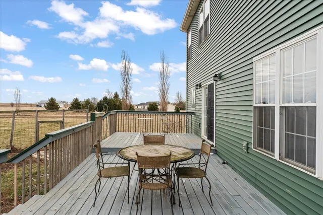 a view of a balcony with a table and chairs and wooden floor