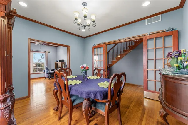 a view of a dining room with furniture and wooden floor