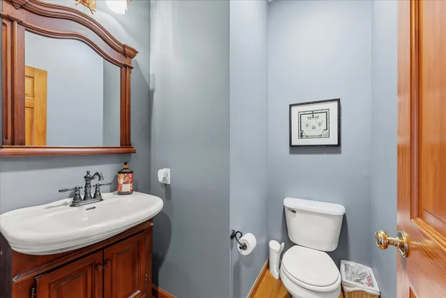 a bathroom with a sink a toilet and mirror
