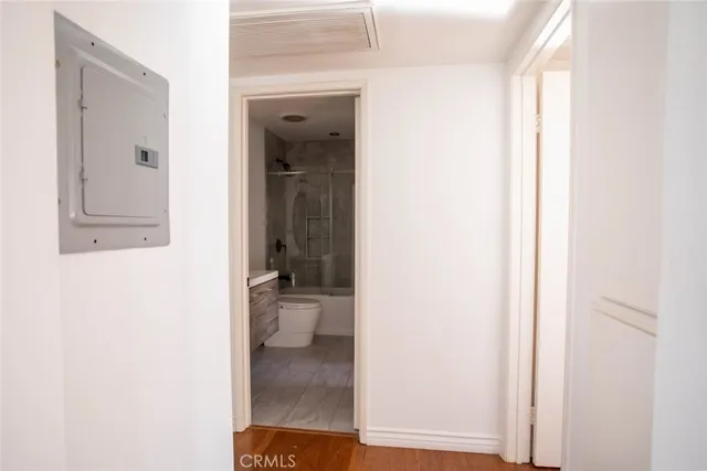 a view of a hallway with wooden floor