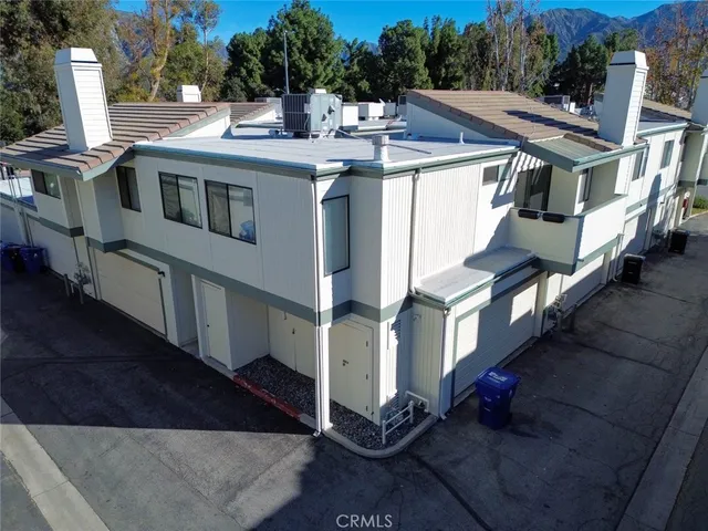 a view of a house with pool and trees
