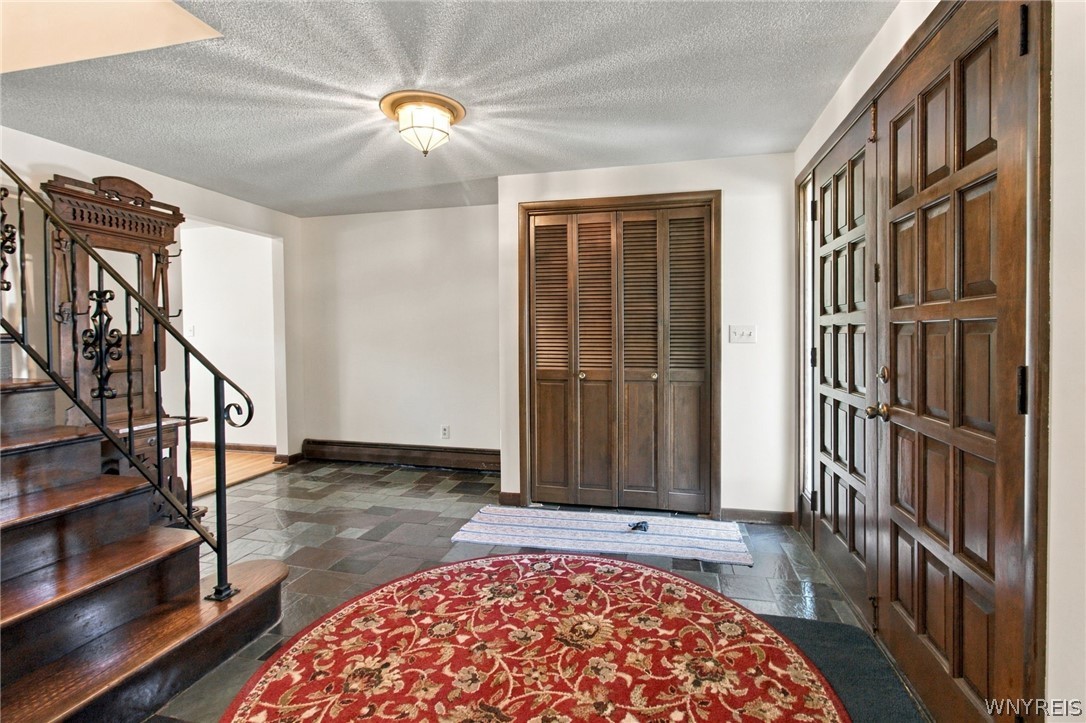 123 Ranch Trail West Amherst, NY 14221 - Photo 29 of 38 Rich wood double entry doors open into a welcoming foyer with natural slate tile flooring.