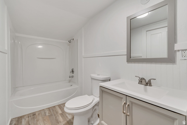 8831 South 400 East Sandy, UT 84070 - Photo 17 of 26 Bathroom featuring light wood-type flooring, vanity, and bathing tub / shower combination