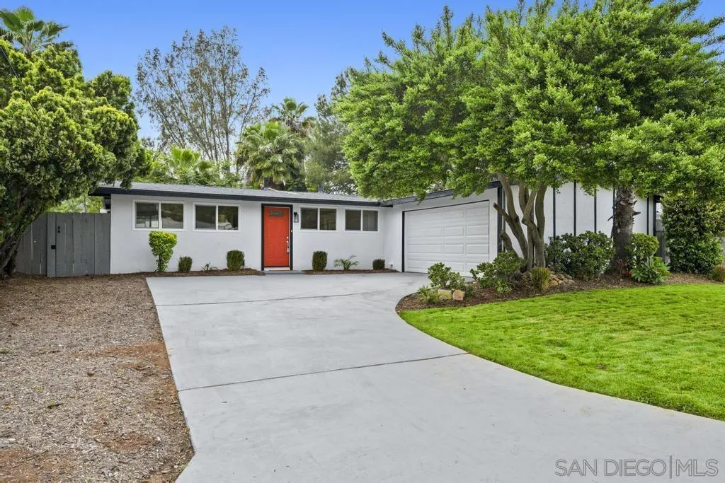 a view of house with yard and green space