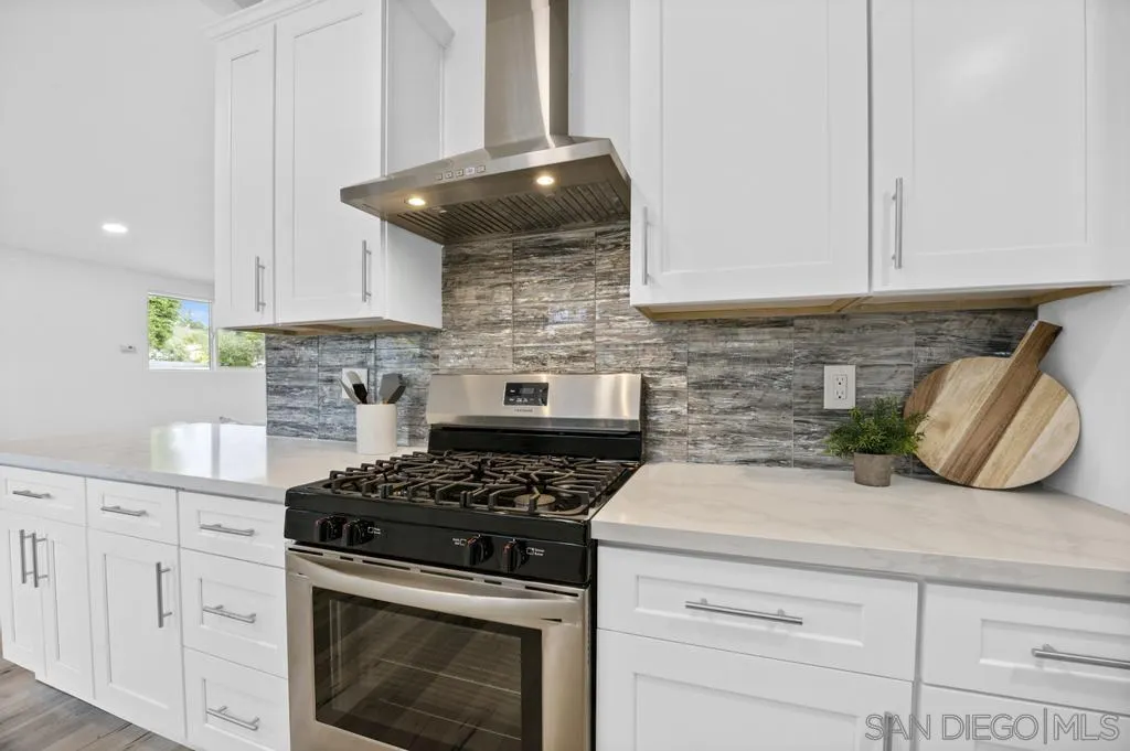 13746 Frame Road Poway, CA 92064 - Photo 18 of 35 a kitchen with a stove and white cabinets