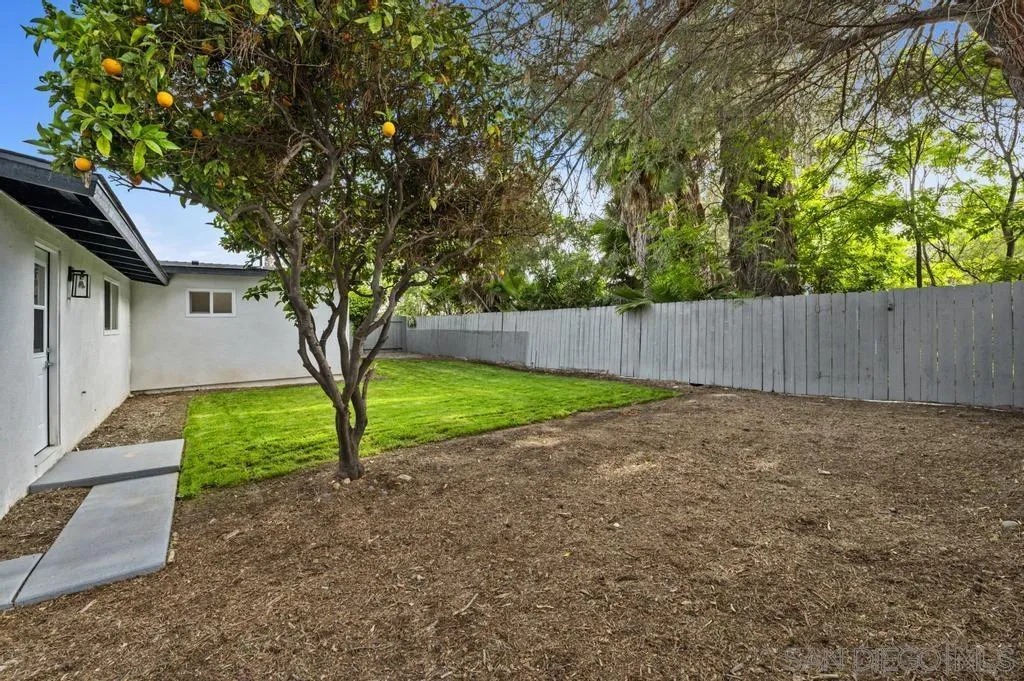 13746 Frame Road Poway, CA 92064 - Photo 34 of 35 a view of a backyard with large trees and wooden fence