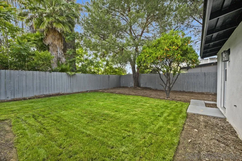 13746 Frame Road Poway, CA 92064 - Photo 35 of 35 a view of a backyard with large trees and wooden fence