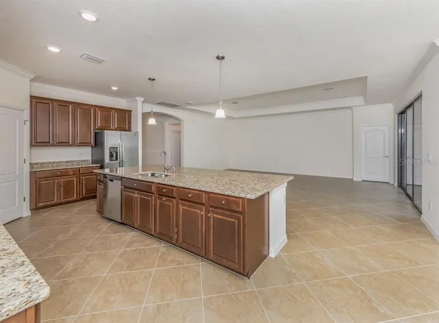 a kitchen with stainless steel appliances granite countertop a sink and cabinets