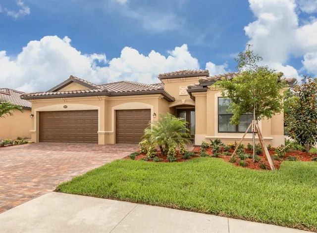 a view of a house with a yard and sitting area