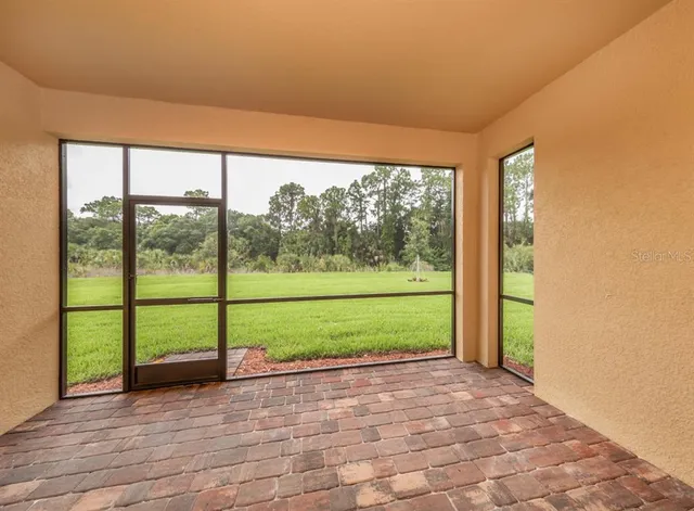 a view of a yard with wooden floor and fence