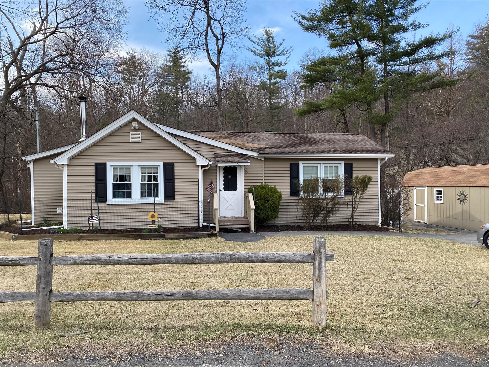 168 Prospect Road Monroe, NY 10950 - Photo 1 of 15 View of front of property with fence, a shed, entry steps, an outdoor structure, and a front lawn