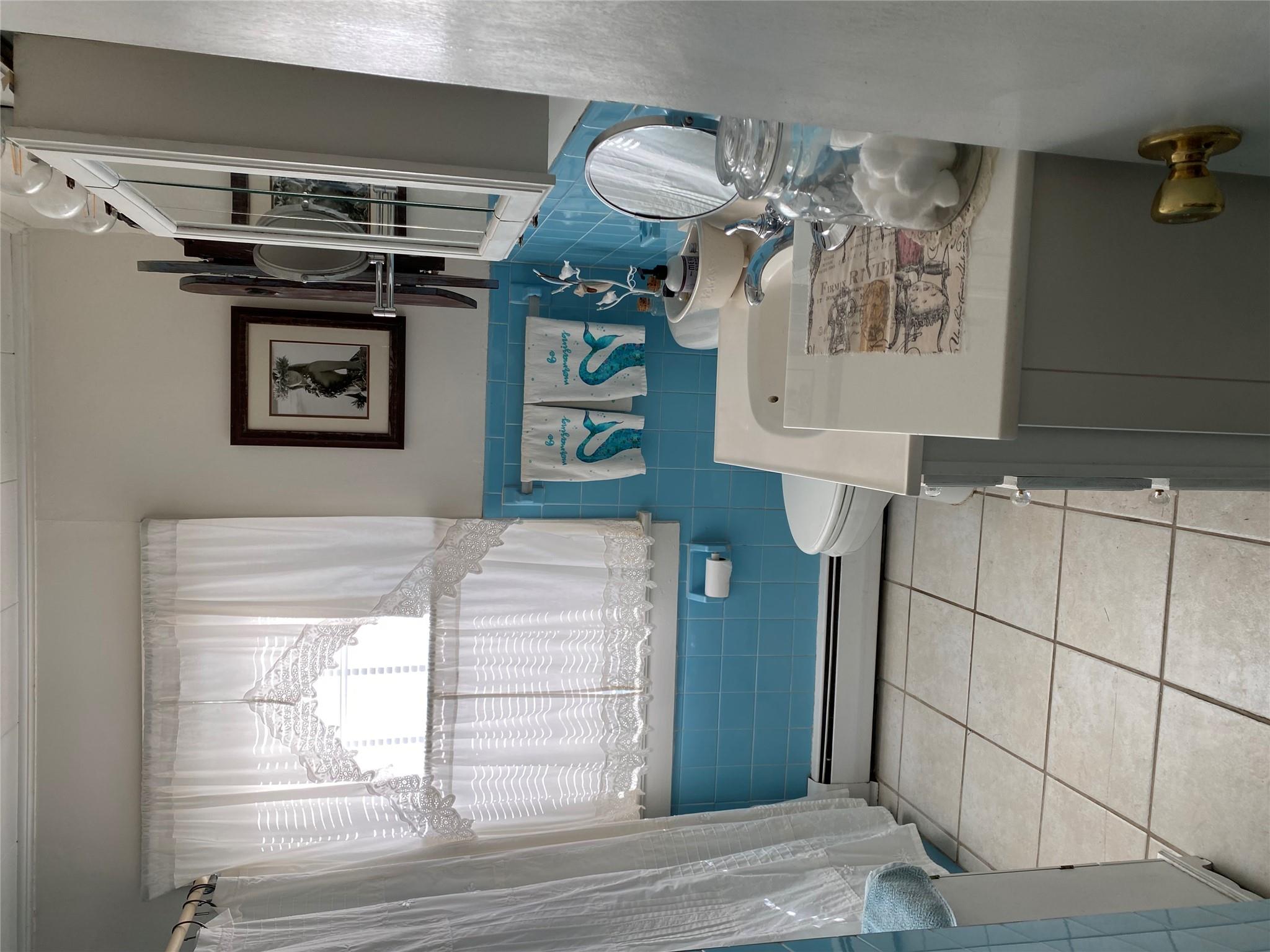 168 Prospect Road Monroe, NY 10950 - Photo 13 of 15 Bathroom with tile patterned floors, toilet, a baseboard heating unit, tile walls, and vanity