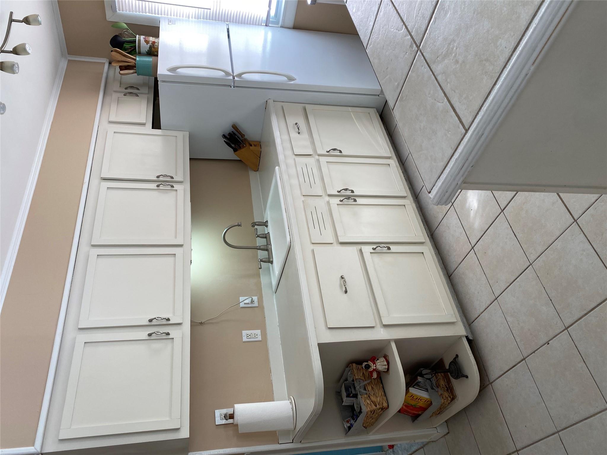 168 Prospect Road Monroe, NY 10950 - Photo 8 of 15 Kitchen featuring light tile patterned floors, a sink, light countertops, crown molding, and fridge