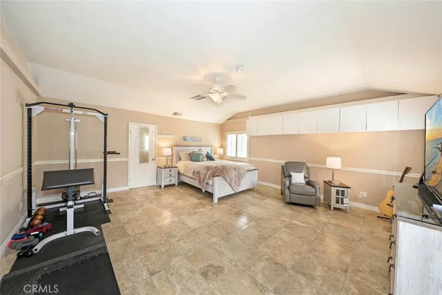 a bed room with a bed furniture and a flat screen tv