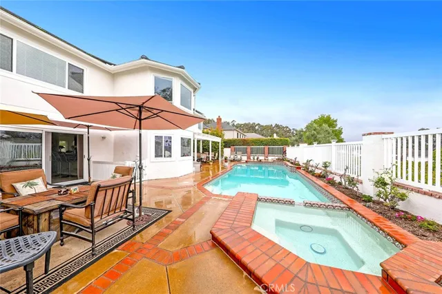 swimming pool view with a seating space