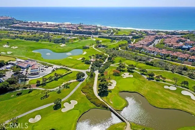 an aerial view of a house with a garden and lake view