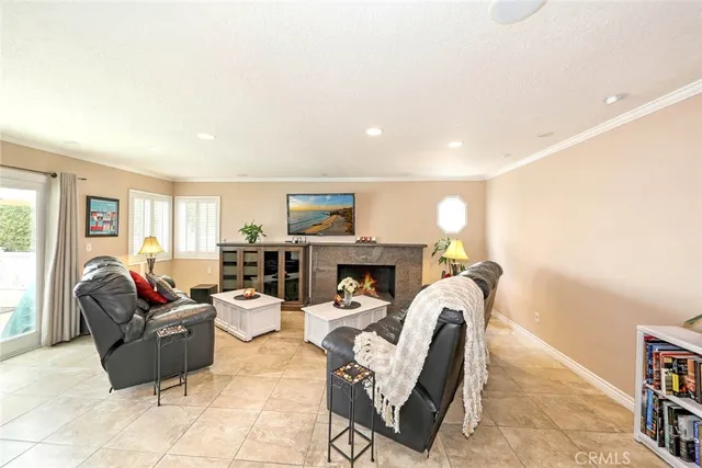 a living room with furniture a fireplace and a potted plant