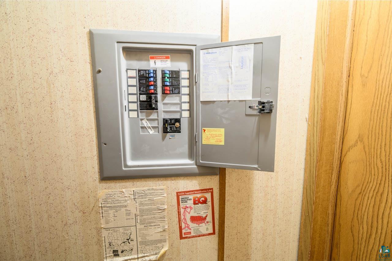 705 4th Street North Biwabik, MN 55708 - Photo 21 of 29 Electrical service panel featuring an open metal door, visible circuit breakers, and internal labeling
