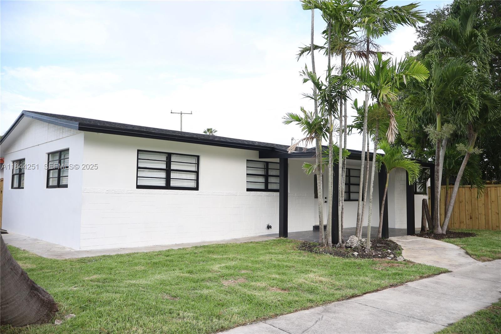 3955 Southwest 69th Avenue Miami, FL 33155 - Photo 1 of 35 front view of house with a yard