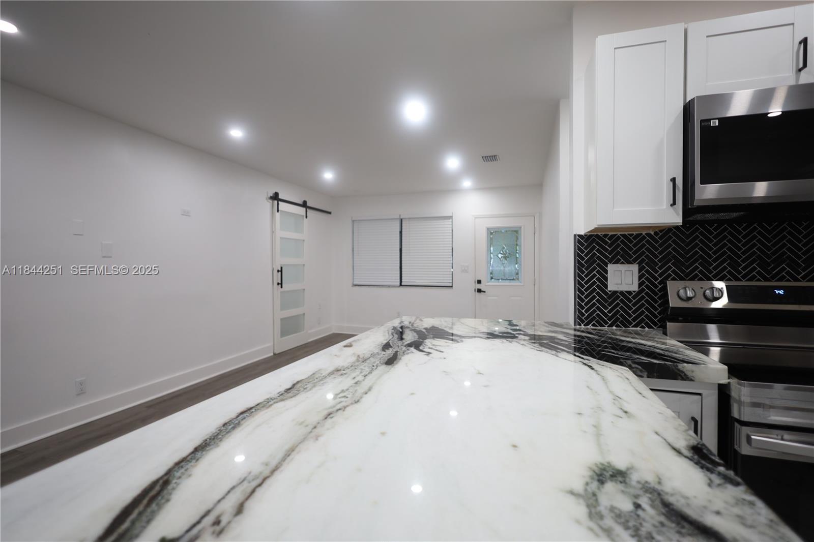 3955 Southwest 69th Avenue Miami, FL 33155 - Photo 13 of 35 a view of kitchen with refrigerator and microwave