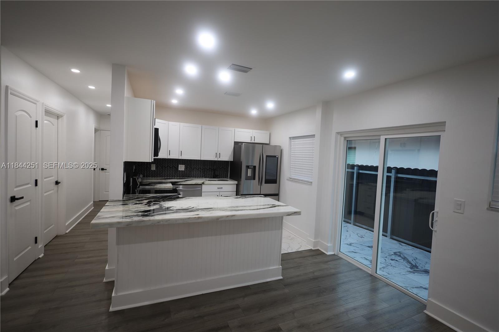 3955 Southwest 69th Avenue Miami, FL 33155 - Photo 14 of 35 a kitchen with kitchen island stainless steel appliances a refrigerator and a stove top oven