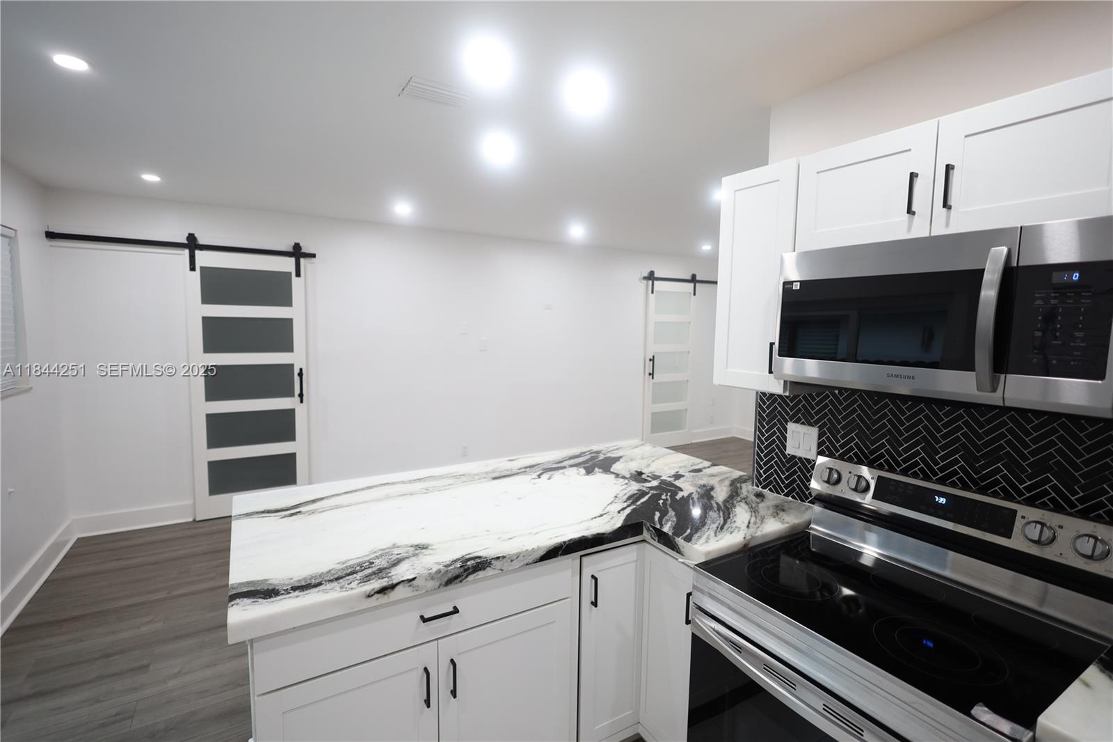 3955 Southwest 69th Avenue Miami, FL 33155 - Photo 16 of 35 a kitchen with a sink stove and microwave