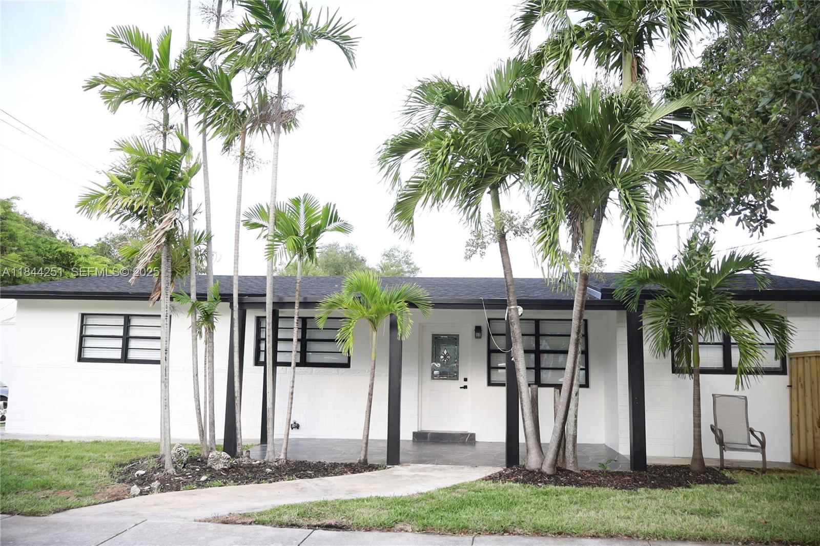 3955 Southwest 69th Avenue Miami, FL 33155 - Photo 2 of 35 a front view of a house with garden