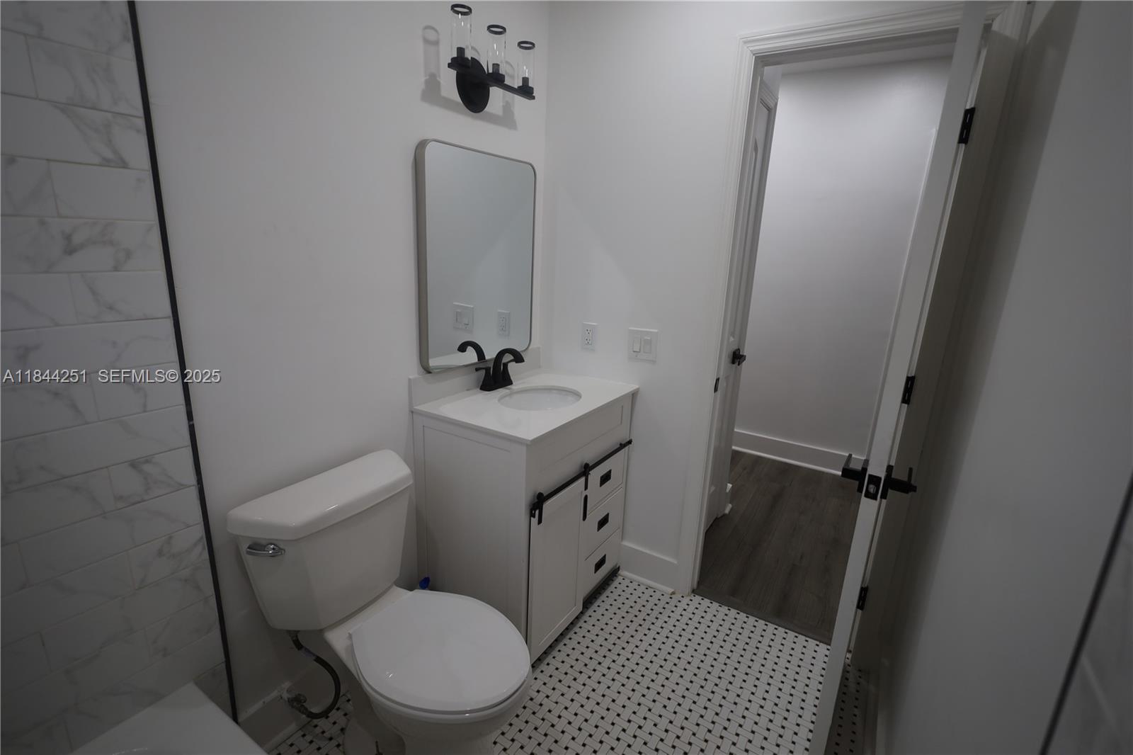 3955 Southwest 69th Avenue Miami, FL 33155 - Photo 22 of 35 a bathroom with a toilet sink and vanity