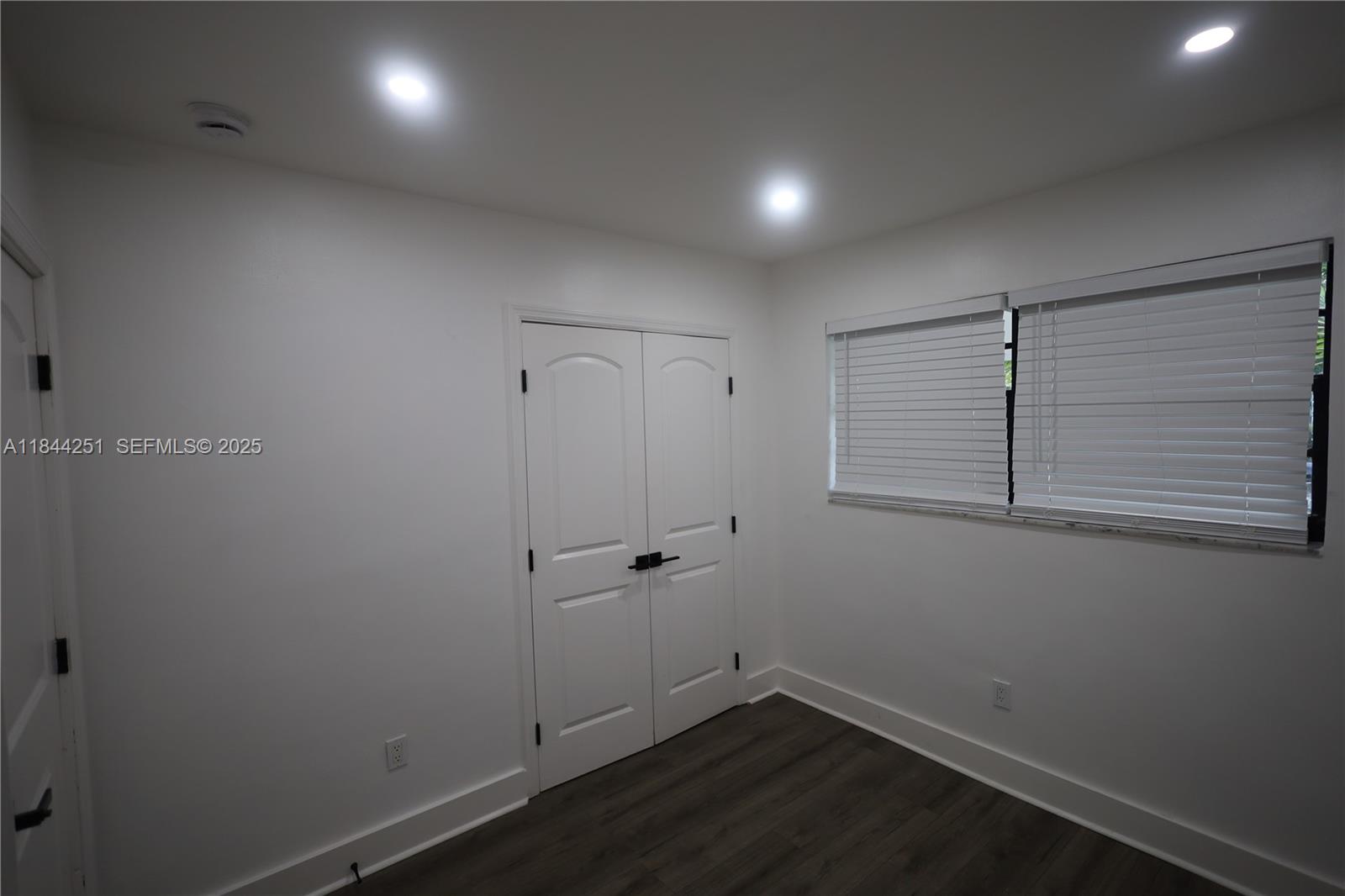 3955 Southwest 69th Avenue Miami, FL 33155 - Photo 25 of 35 an empty room with wooden floor and window