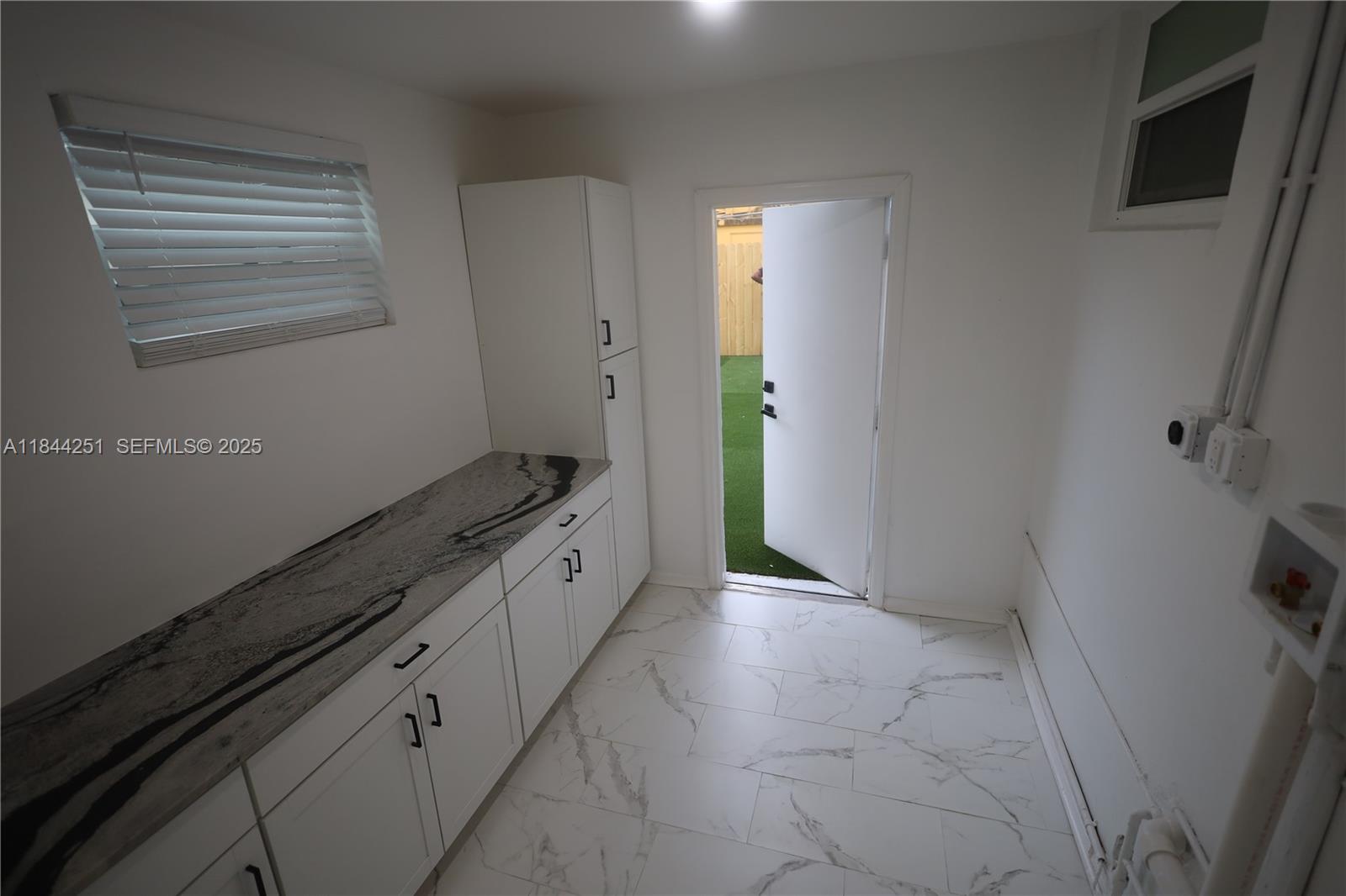 3955 Southwest 69th Avenue Miami, FL 33155 - Photo 28 of 35 a spacious bathroom with a granite countertop sink and a mirror