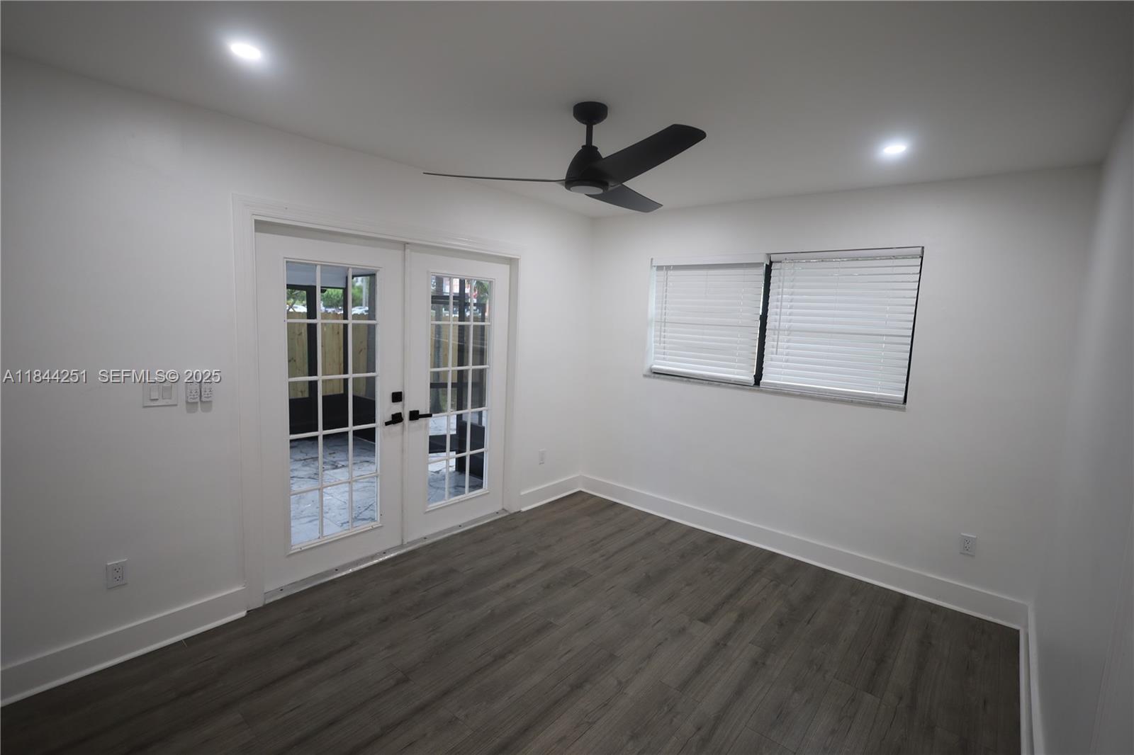 3955 Southwest 69th Avenue Miami, FL 33155 - Photo 30 of 35 an empty room with wooden floor and windows