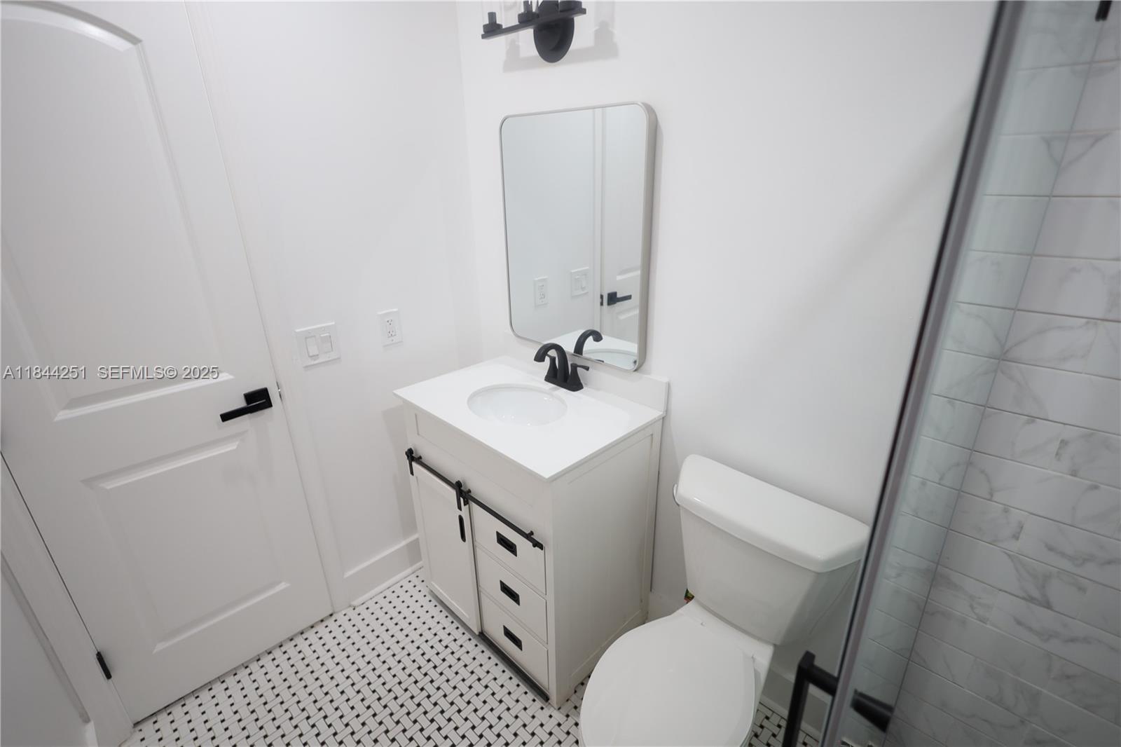 3955 Southwest 69th Avenue Miami, FL 33155 - Photo 31 of 35 a bathroom with a sink toilet and shower