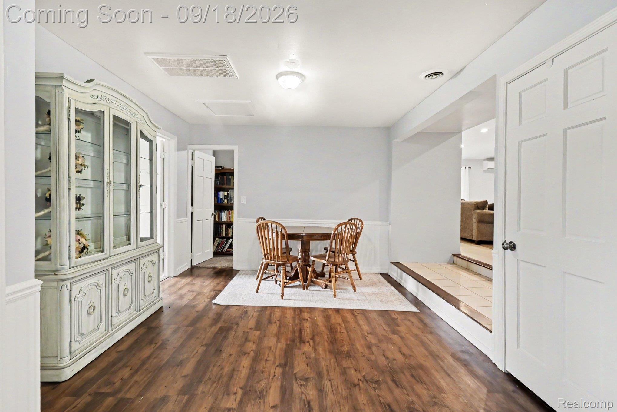 10755 Spencer Road St. Charles, MI 48655 - Photo 12 of 35 Wood-finish flooring, white paneling, and a flush mount ceiling light