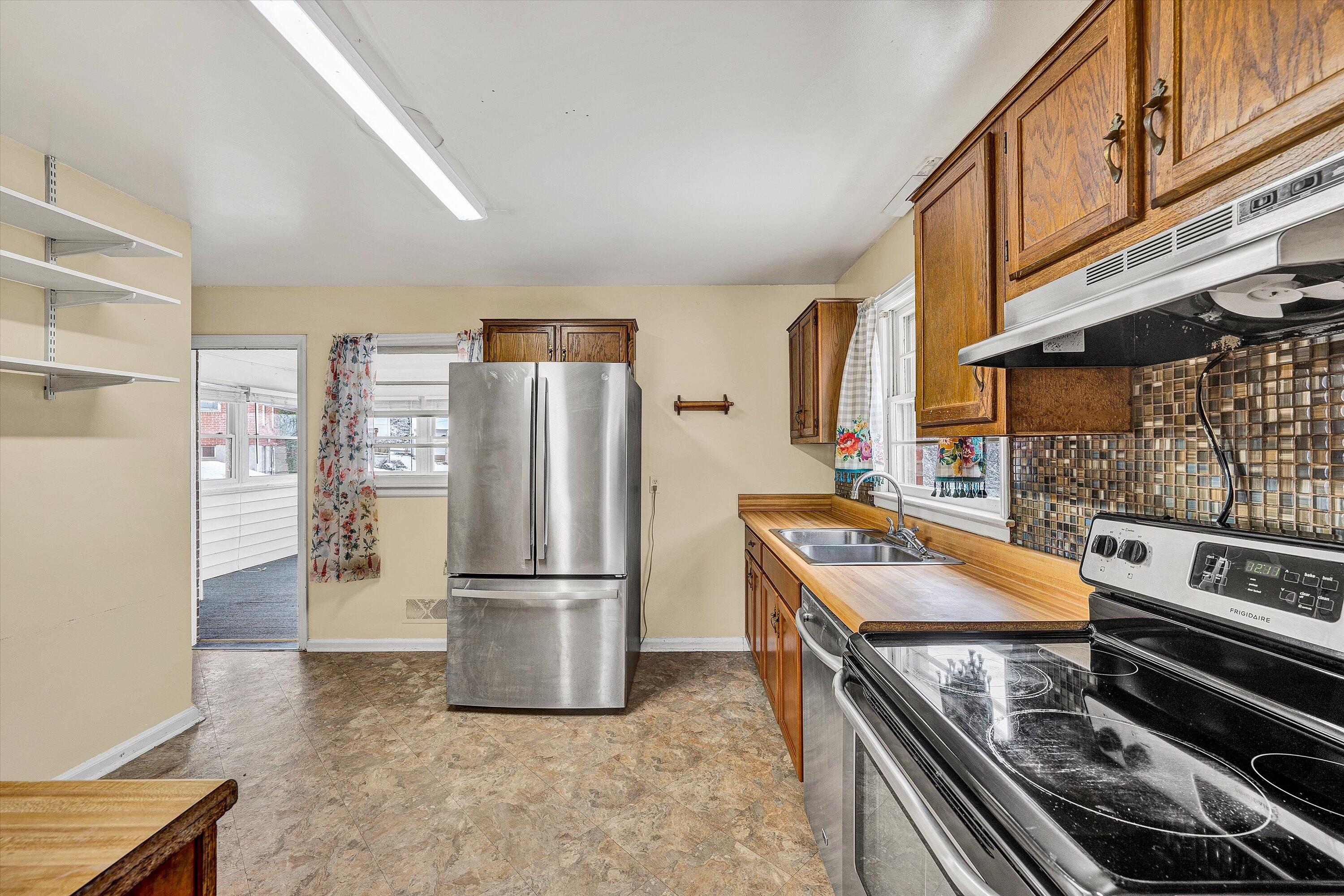 402 Cherryhill Road Northwest Roanoke, VA 24017 - Photo 11 of 42 a kitchen with stainless steel appliances granite countertop a refrigerator and a stove