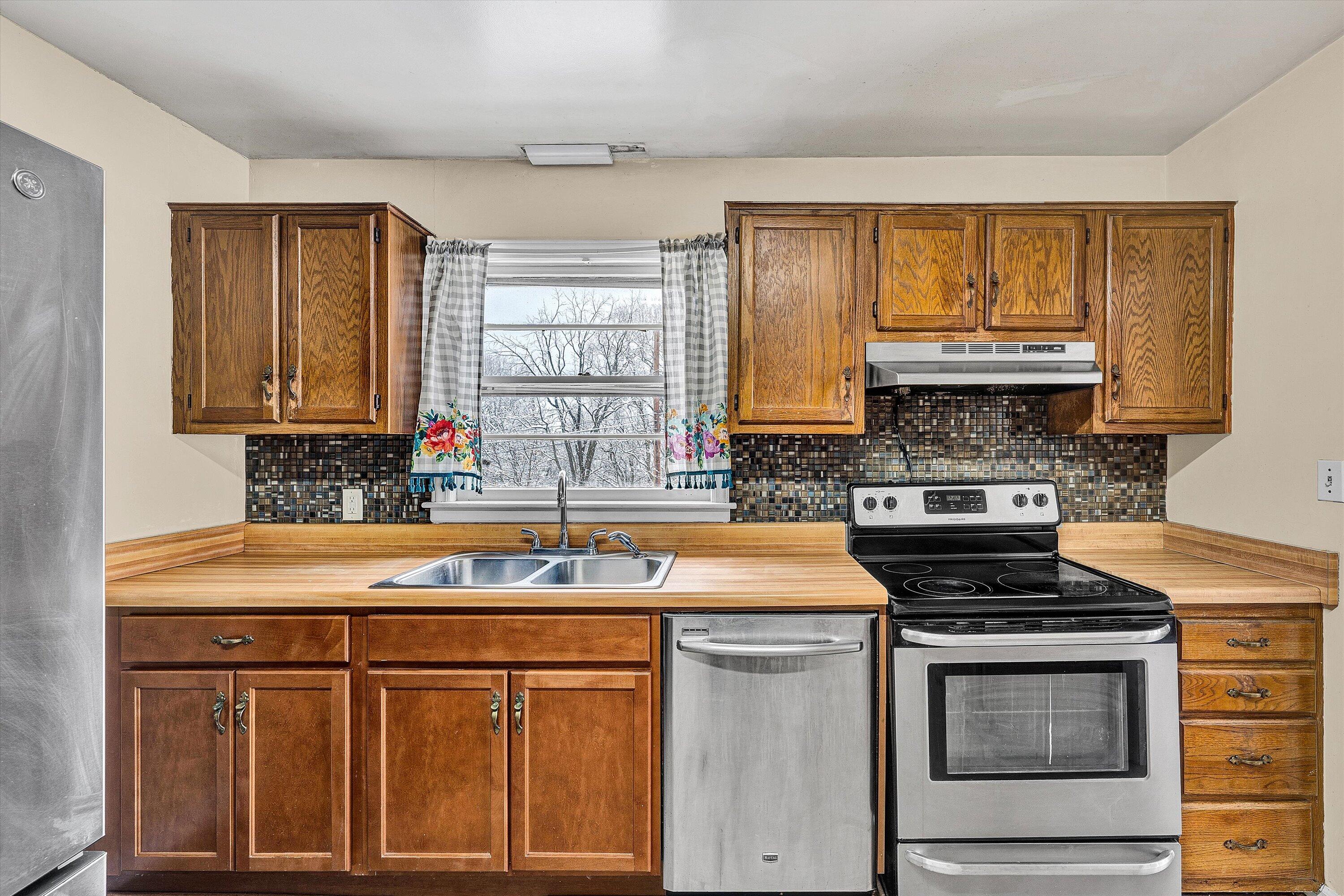 402 Cherryhill Road Northwest Roanoke, VA 24017 - Photo 12 of 42 a kitchen with stainless steel appliances granite countertop a sink stove and cabinets