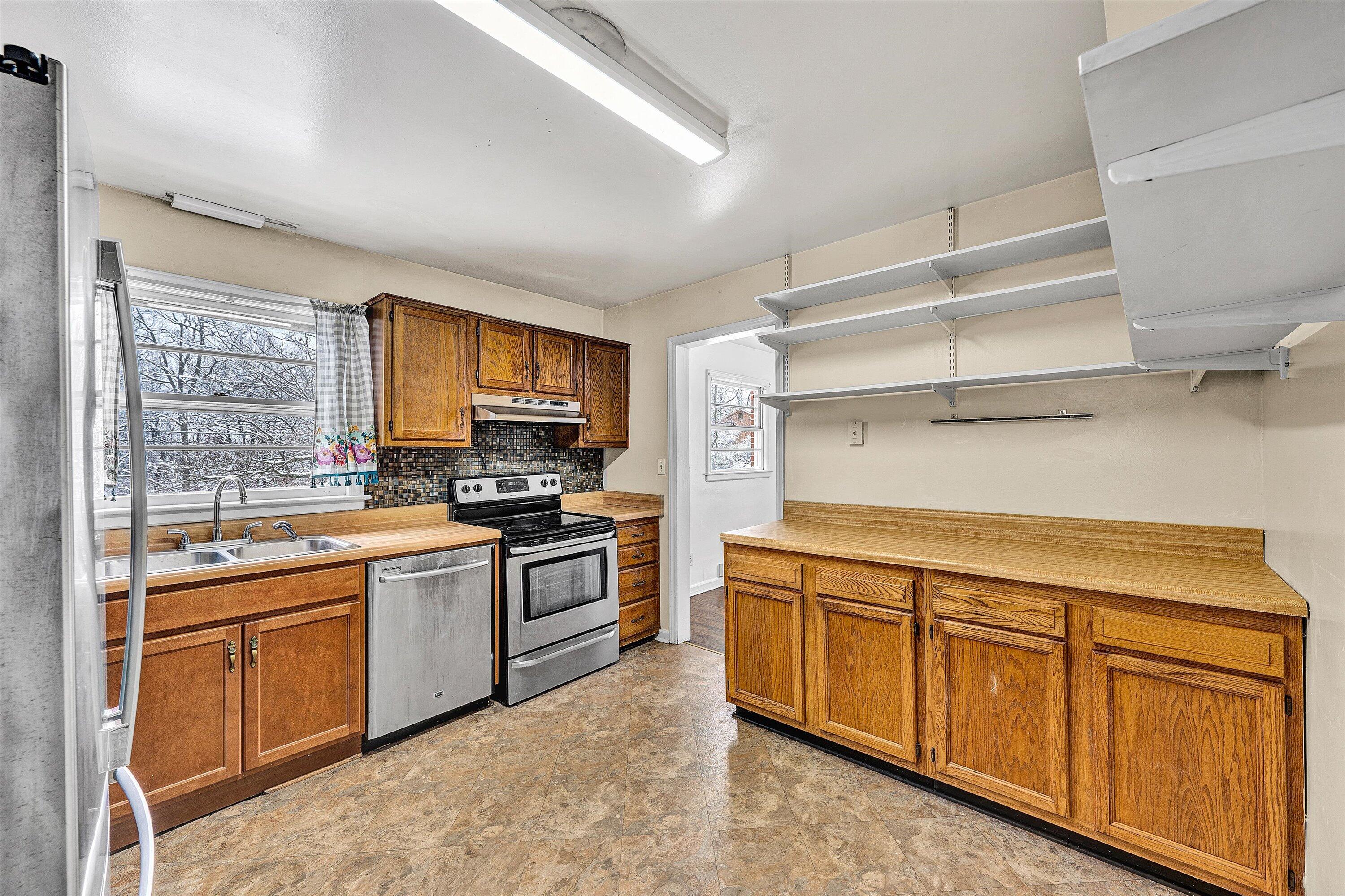 402 Cherryhill Road Northwest Roanoke, VA 24017 - Photo 14 of 42 a kitchen with stainless steel appliances granite countertop a stove sink and cabinets