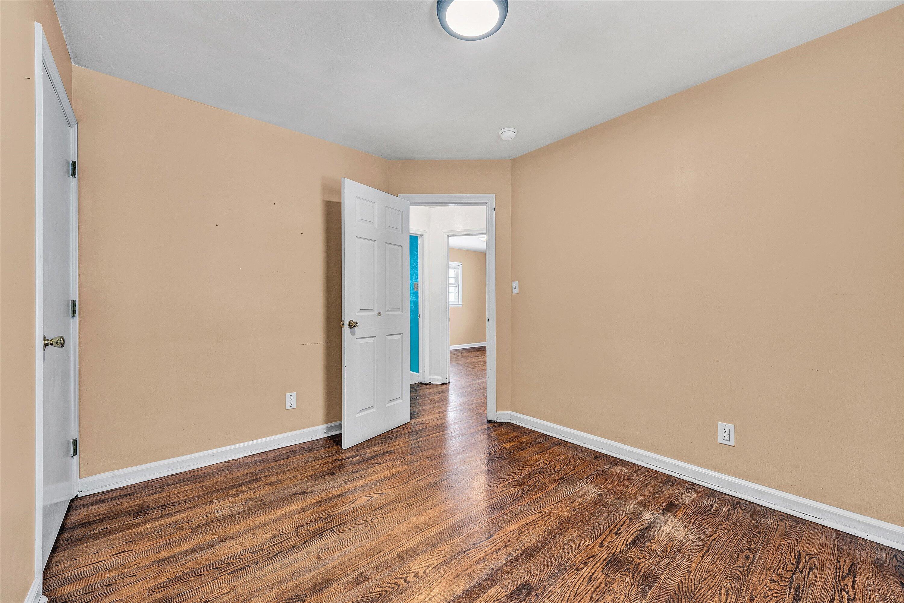 402 Cherryhill Road Northwest Roanoke, VA 24017 - Photo 19 of 42 a view of an empty room with wooden floor and window