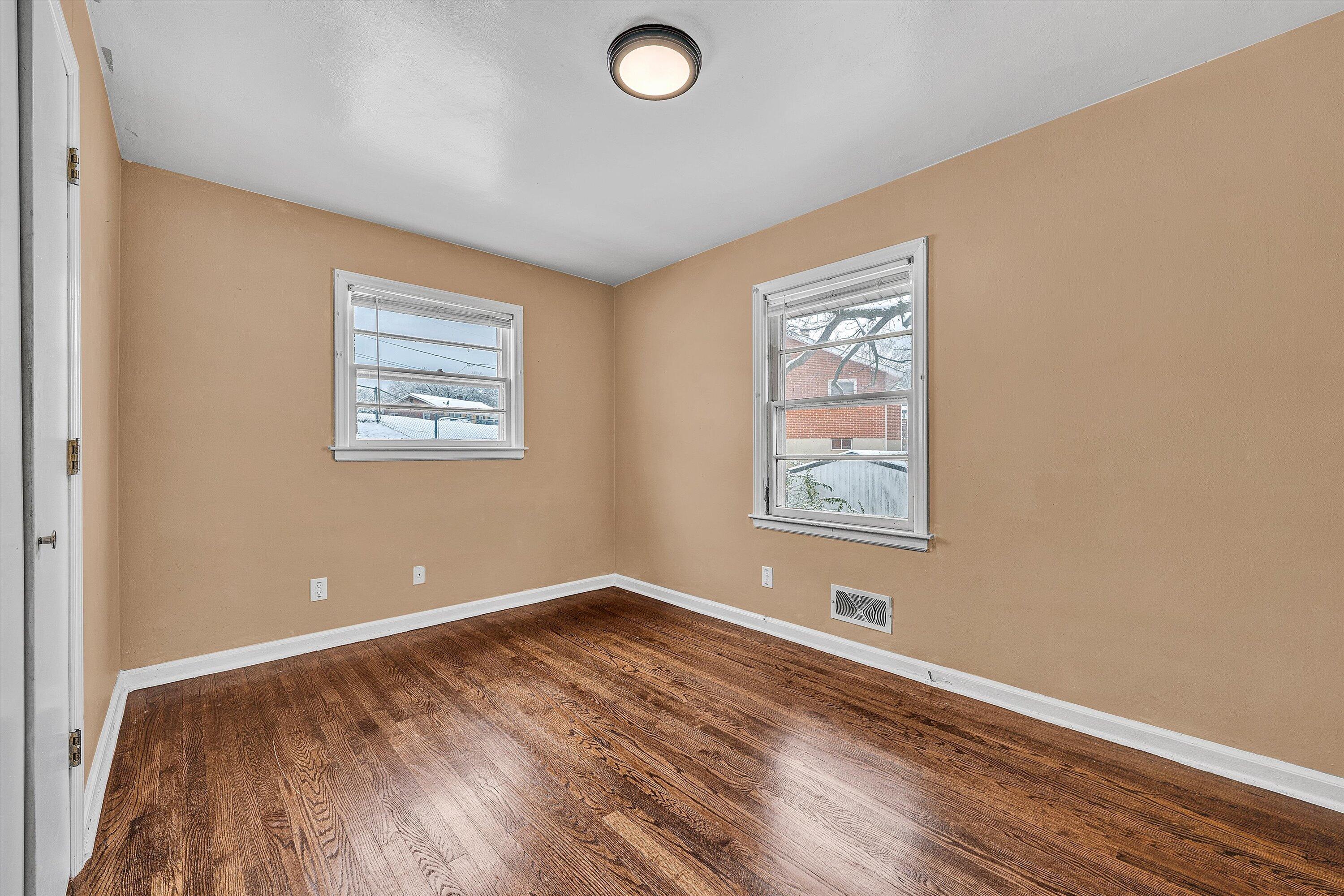 402 Cherryhill Road Northwest Roanoke, VA 24017 - Photo 21 of 42 an empty room with wooden floor and windows