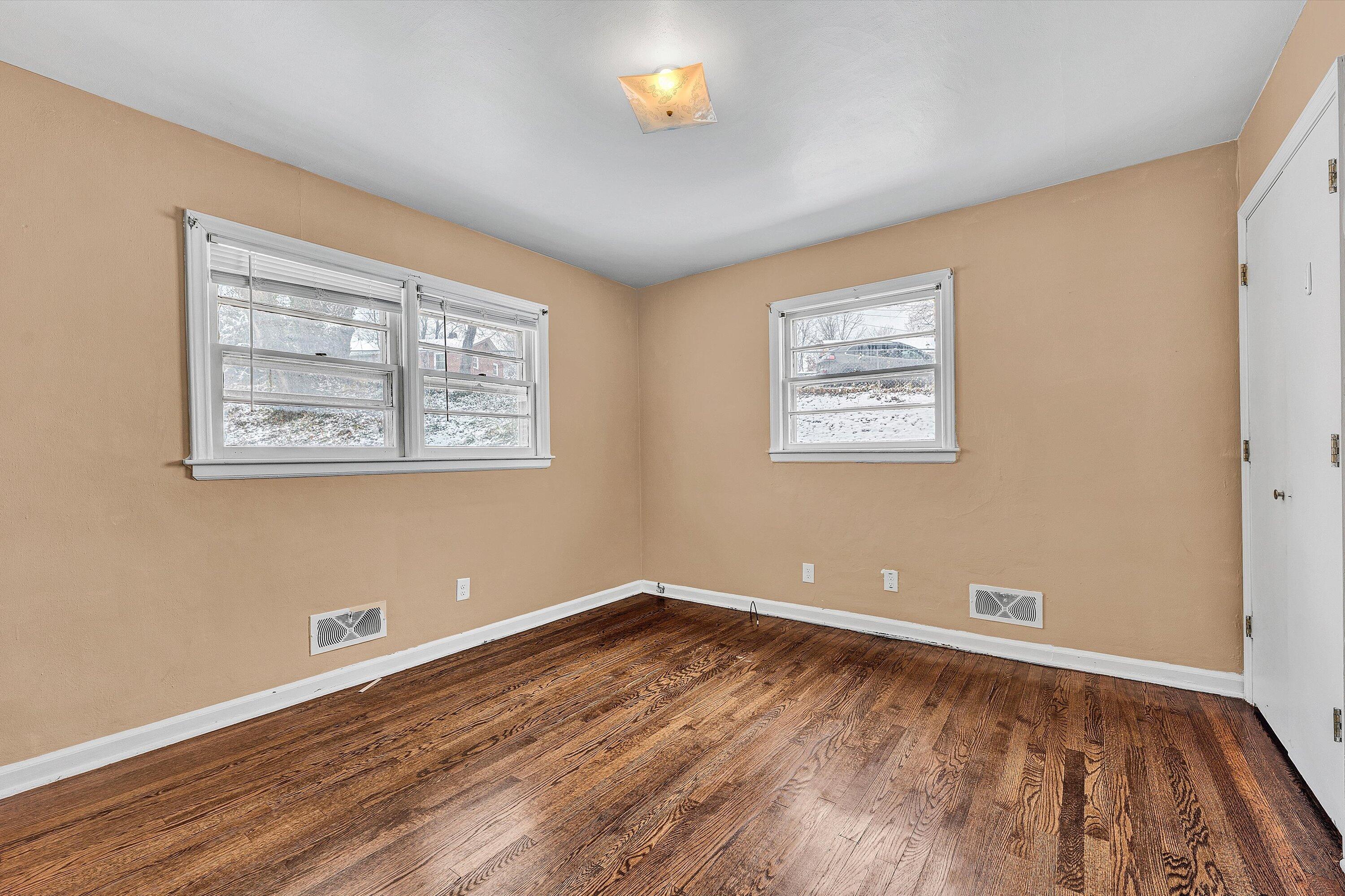 402 Cherryhill Road Northwest Roanoke, VA 24017 - Photo 23 of 42 a view of an empty room with window and wooden floor