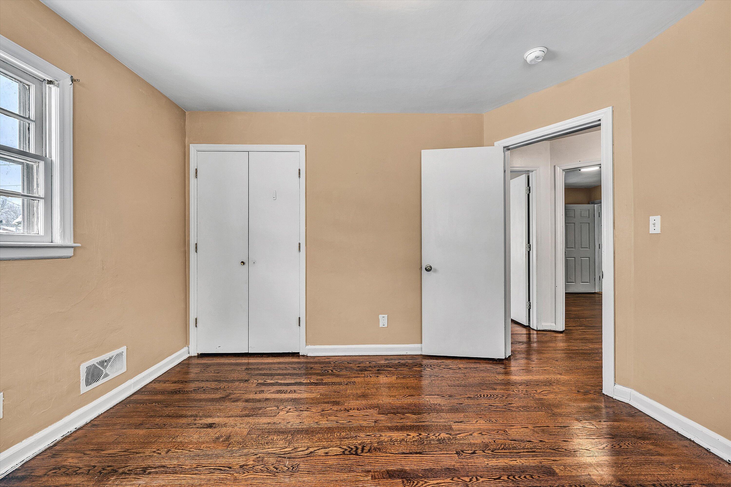 402 Cherryhill Road Northwest Roanoke, VA 24017 - Photo 24 of 42 a view of an empty room with wooden floor and a window