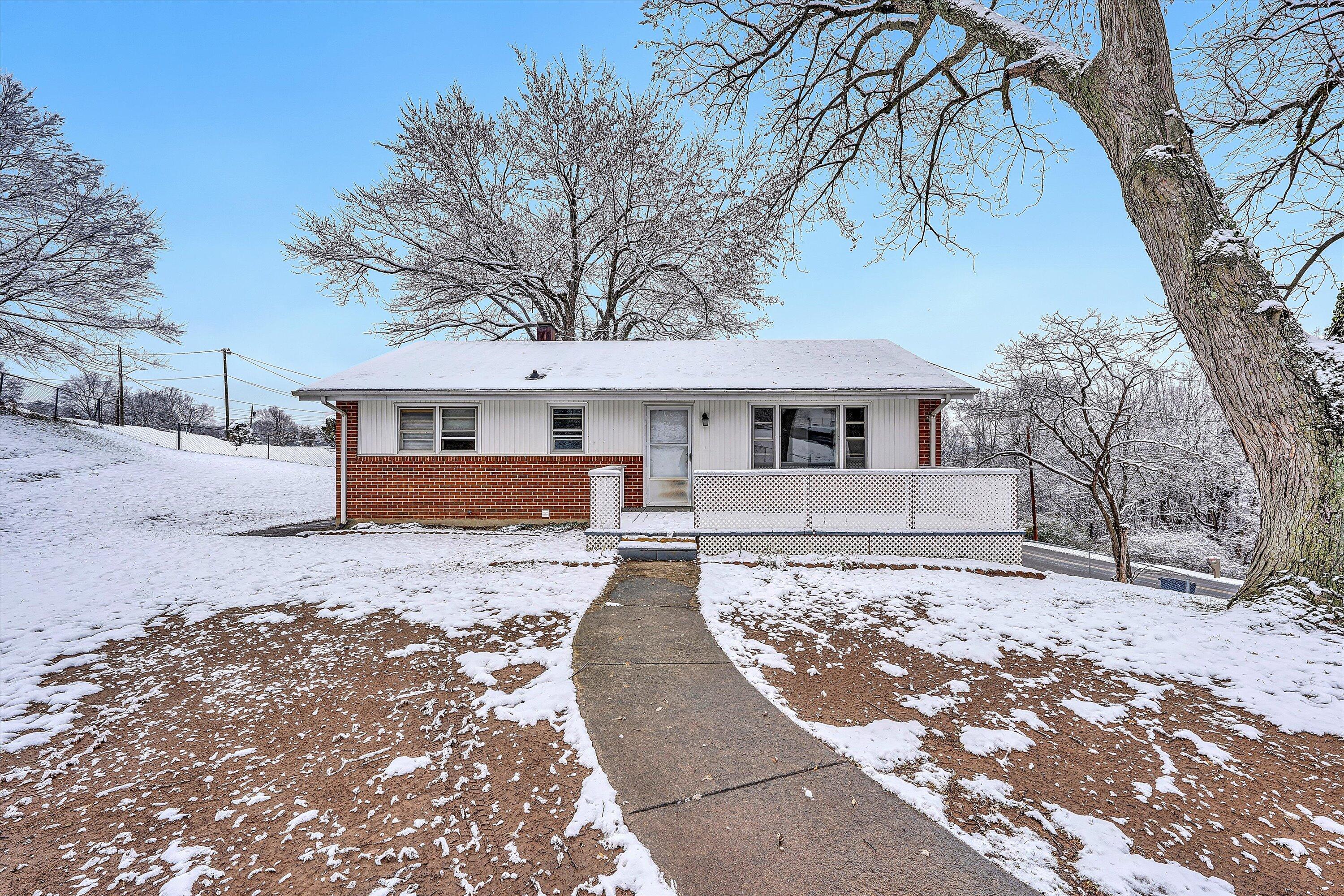 402 Cherryhill Road Northwest Roanoke, VA 24017 - Photo 3 of 42 a front view of a house with a dirt yard and a large tree