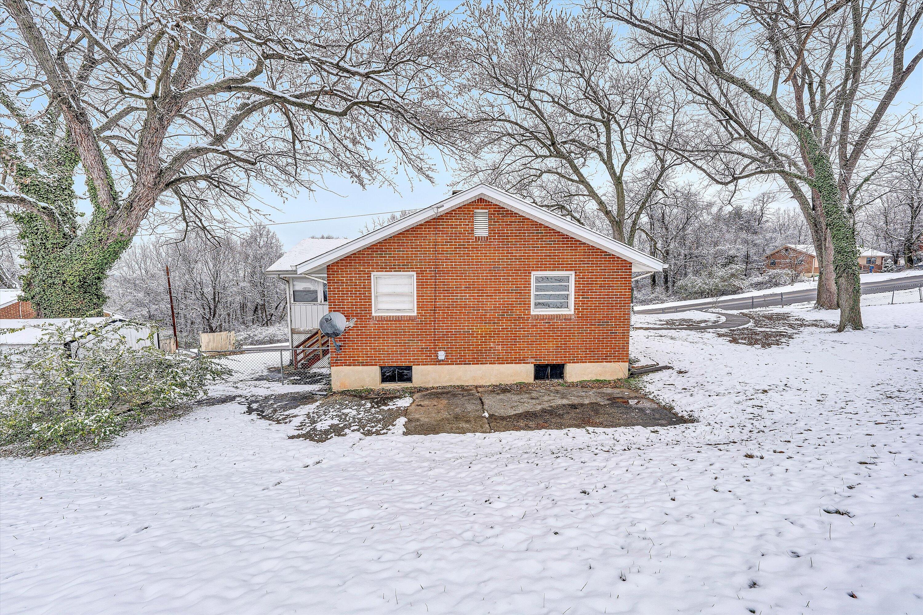 402 Cherryhill Road Northwest Roanoke, VA 24017 - Photo 40 of 42 a front view of a house with a yard covered in snow