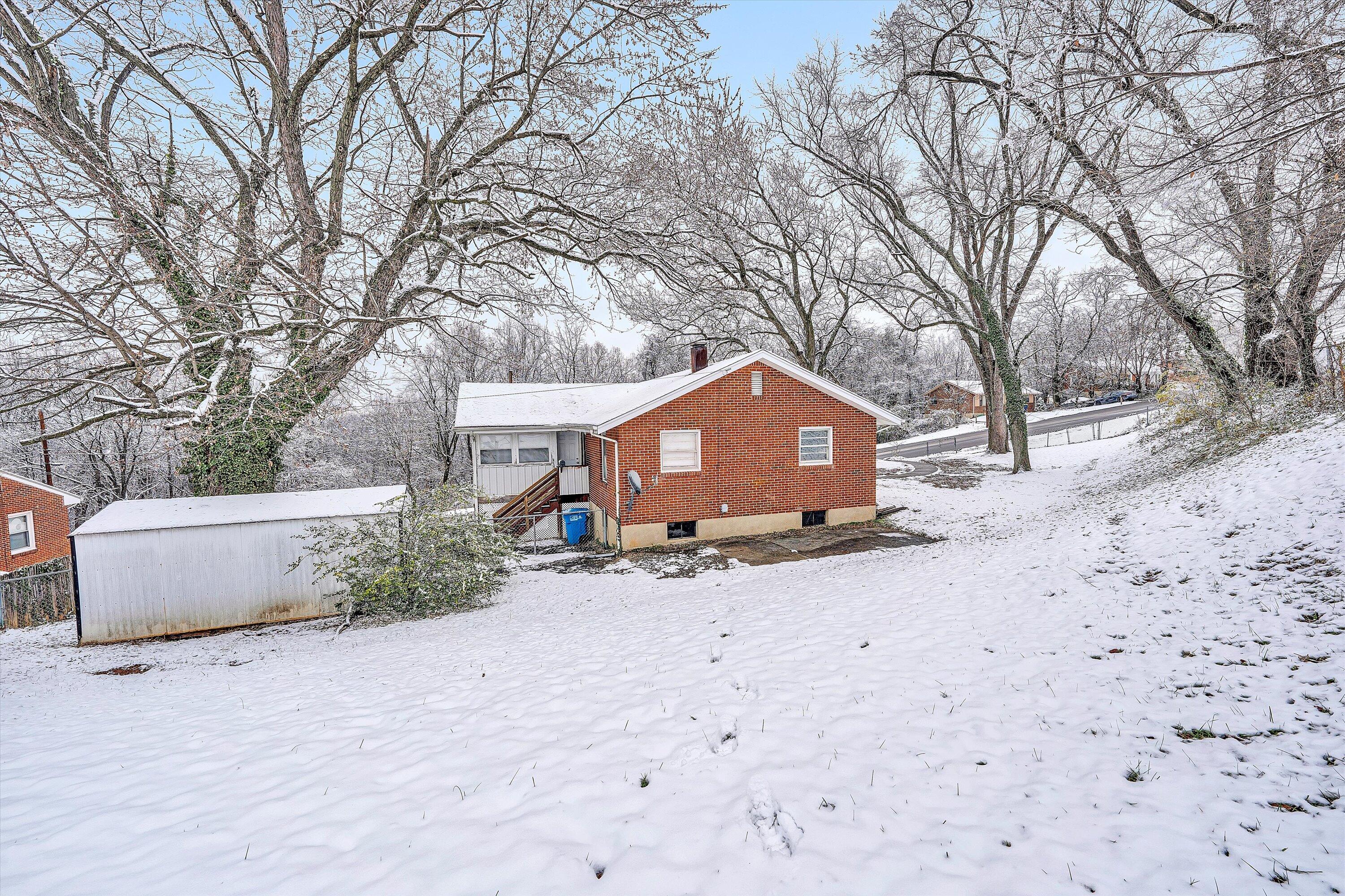 402 Cherryhill Road Northwest Roanoke, VA 24017 - Photo 41 of 42 a view of a house with a yard covered in snow