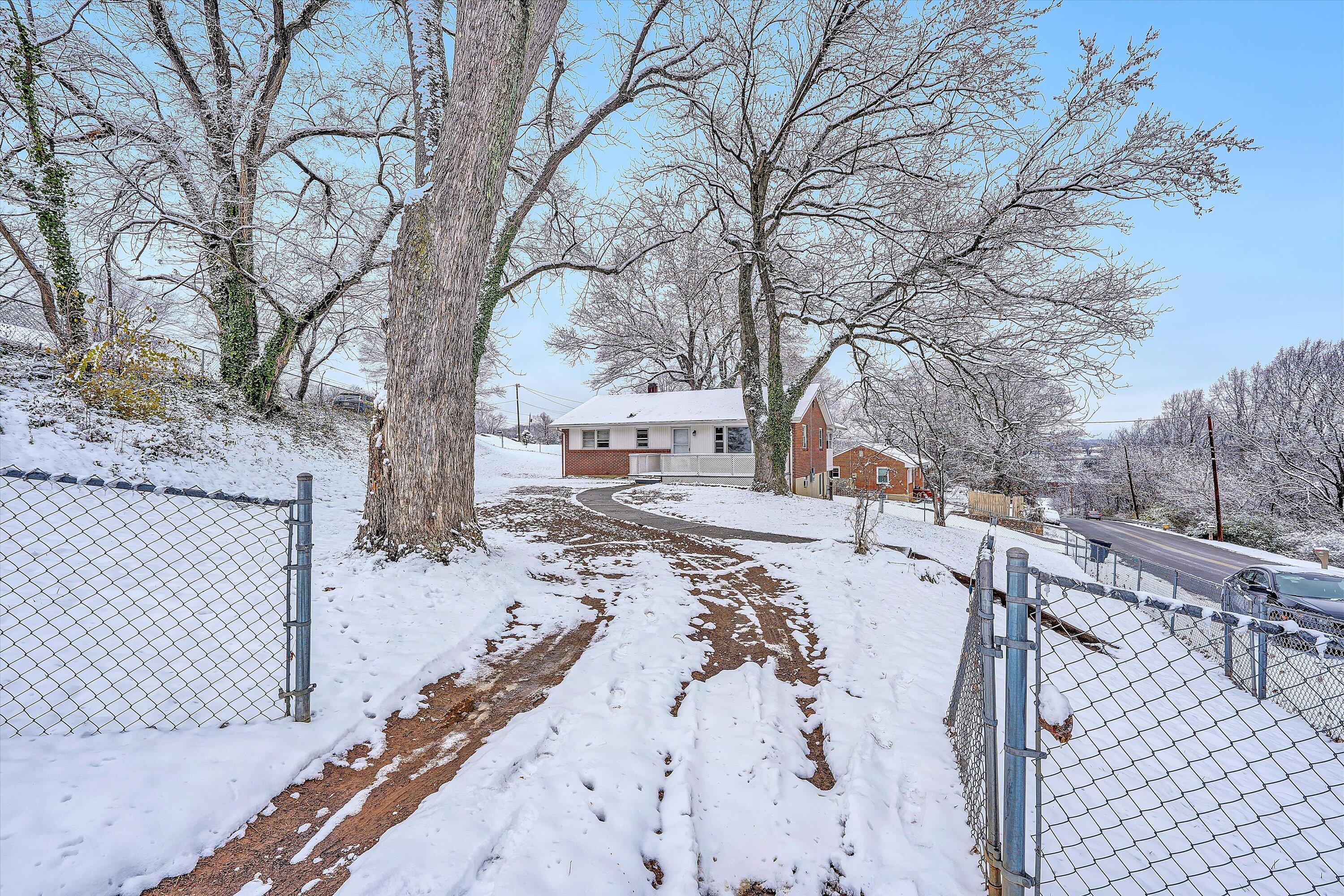 402 Cherryhill Road Northwest Roanoke, VA 24017 - Photo 5 of 42 a view of a yard with snow on the road