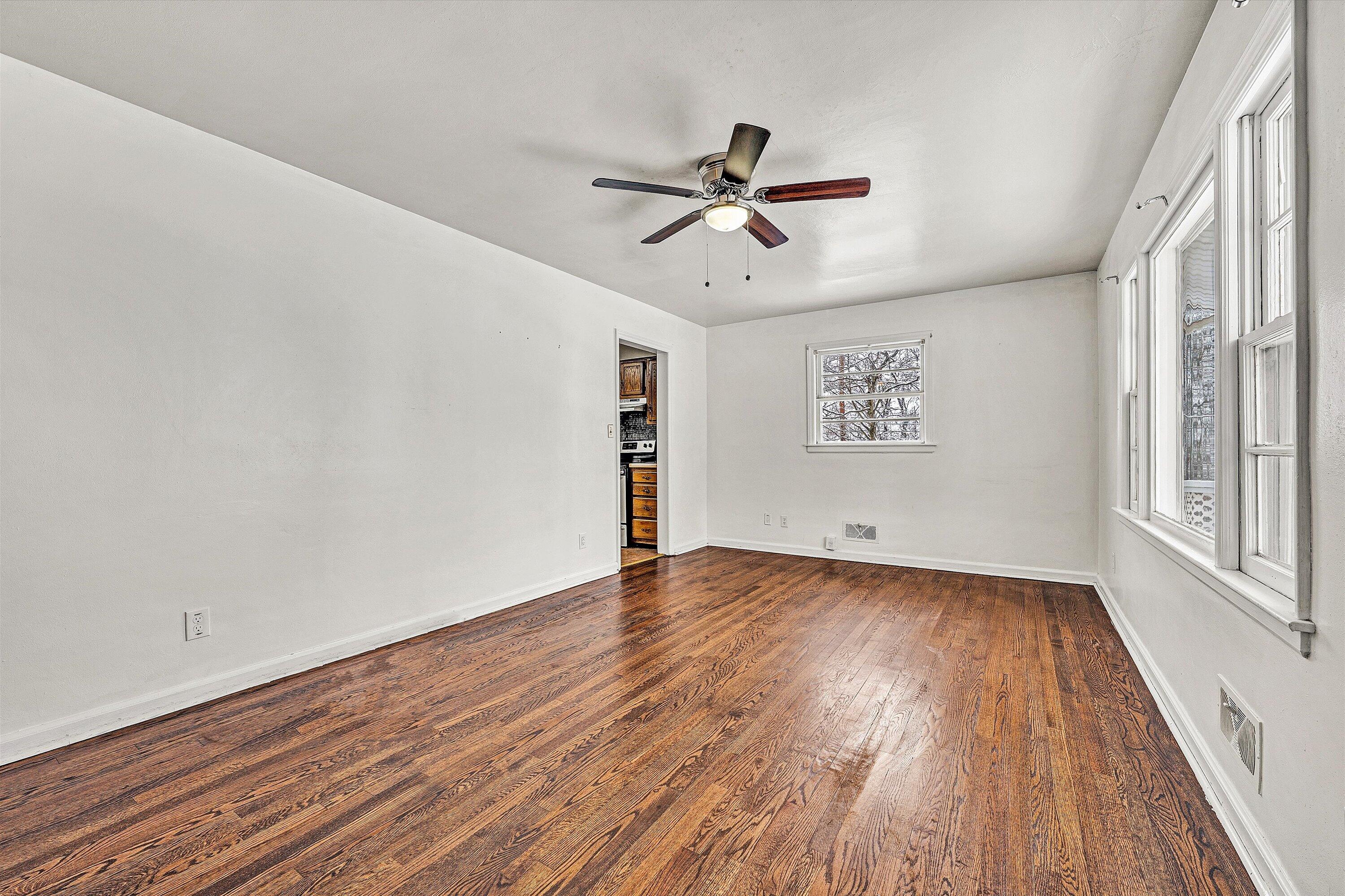 402 Cherryhill Road Northwest Roanoke, VA 24017 - Photo 9 of 42 a view of an empty room with wooden floor and a window
