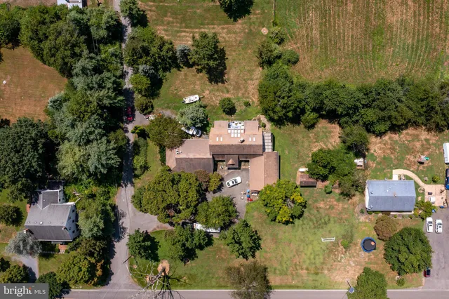 an aerial view of a house with a yard and lake view