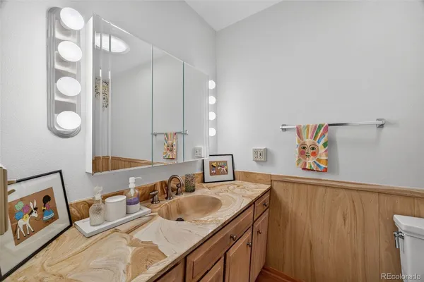 a bathroom with a sink mirror and vanity